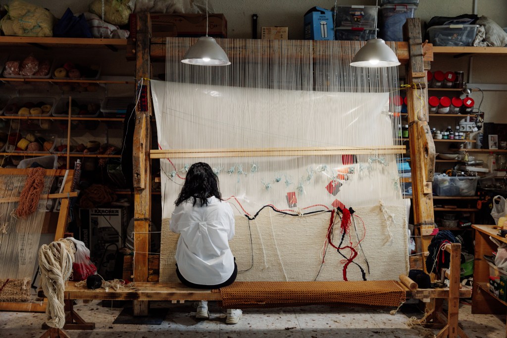 Handwoven rug in traditional Armenian design, restored antique carpet, and natural materials.